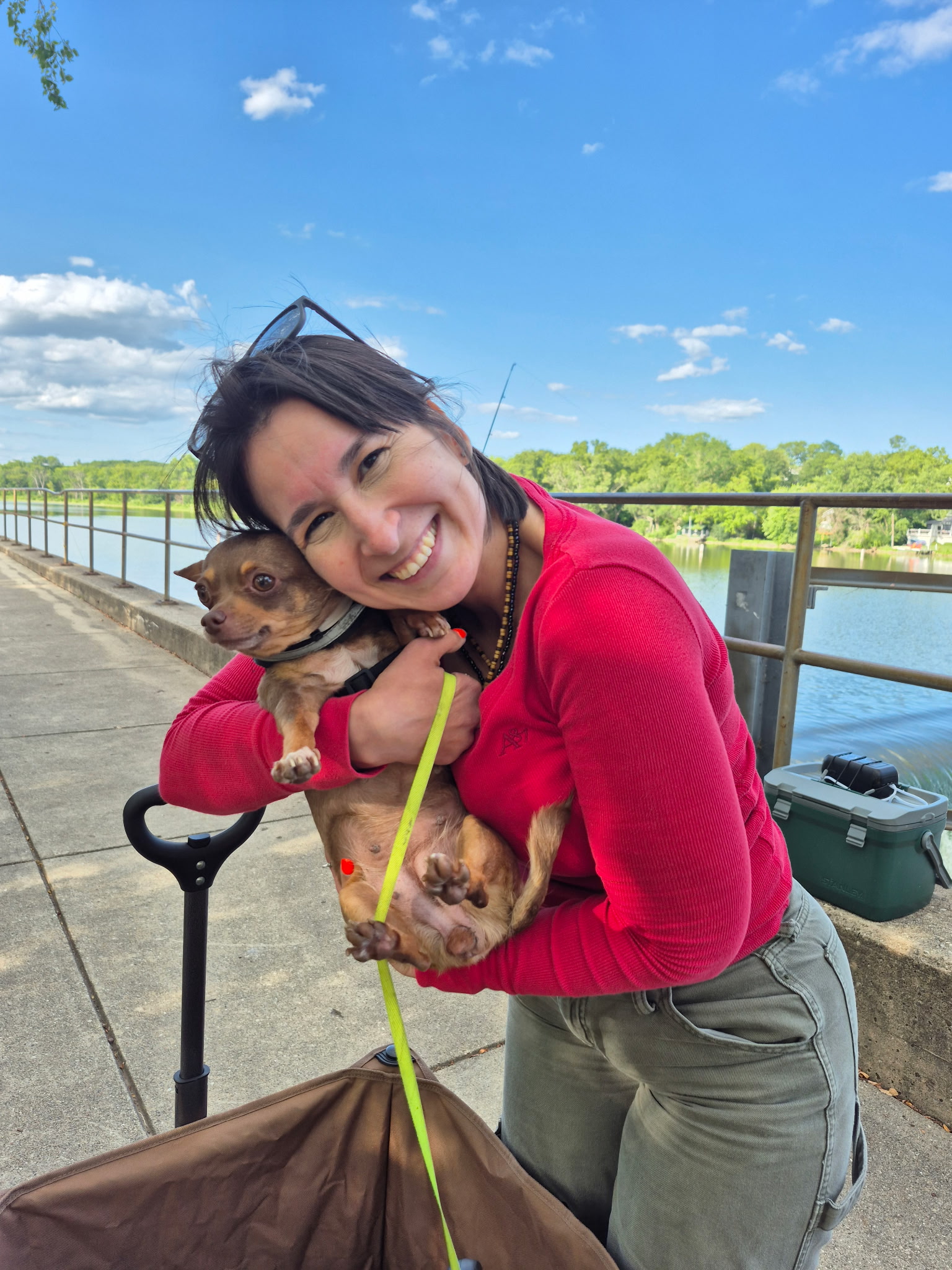 Friend smiling with a Chihuahua during a summer bank fishing trip